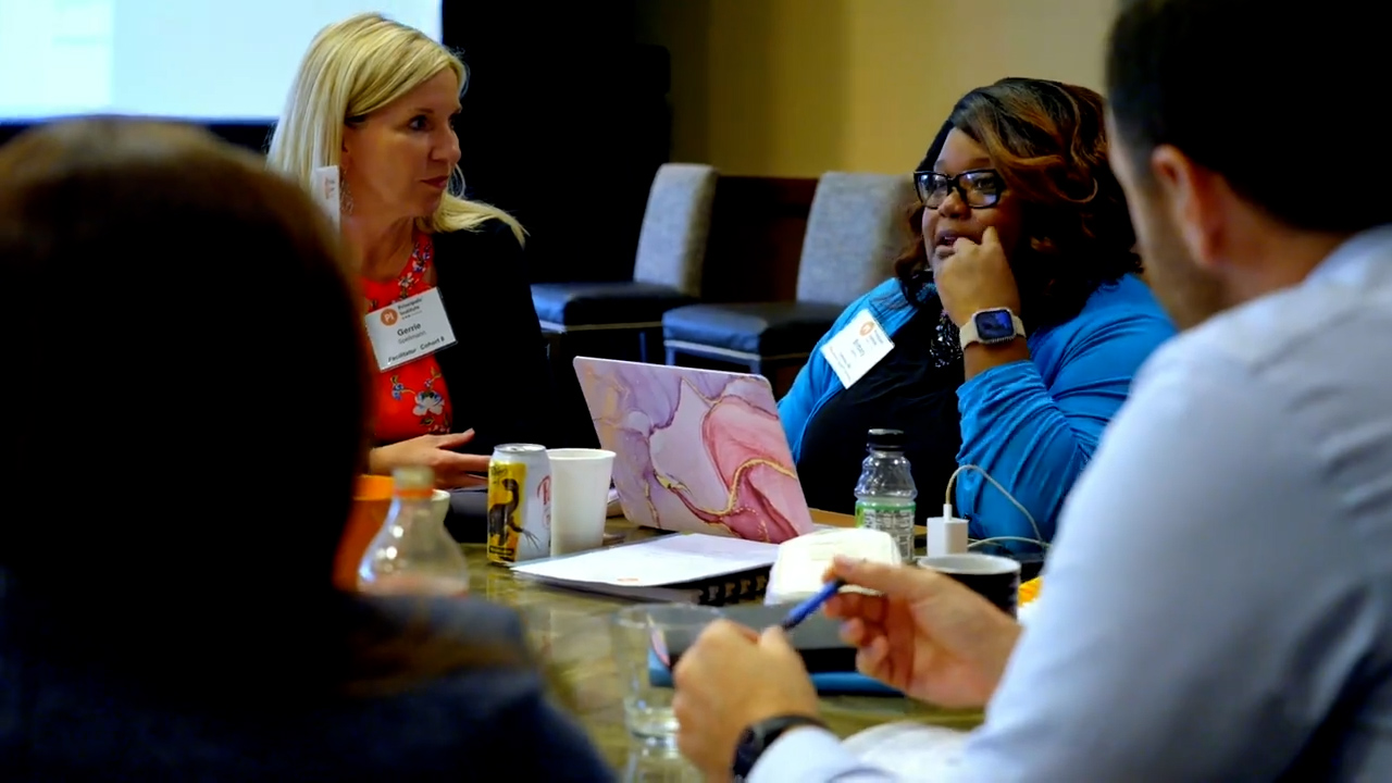 table of people talking at conference